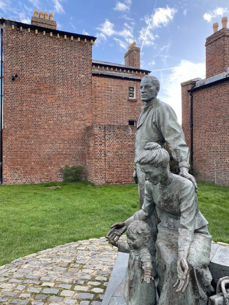 Statue of young immigrant family donated by the LDS church to the city of Liverpool, England